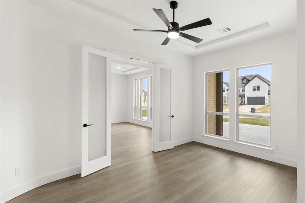 1061 Georgetown Place Prosper, TX 75078 - Photo 4 of 29 wooden floor in an empty room with a window