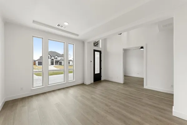 an empty room with wooden floor and closet