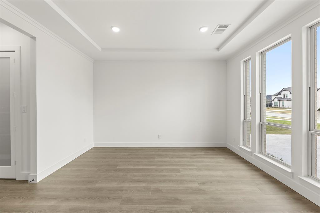 1061 Georgetown Place Prosper, TX 75078 - Photo 6 of 29 wooden floor in an empty room with a window