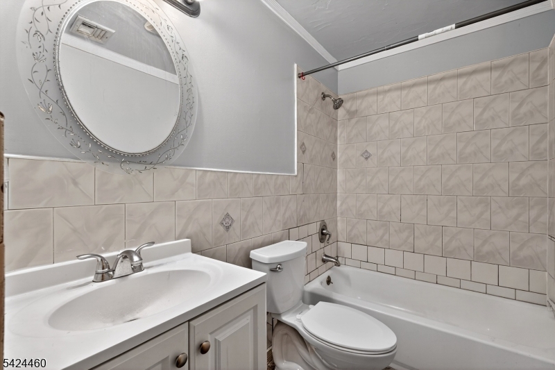 216 New Street, Unit A Orange, NJ 07050 - Photo 12 of 17 a bathroom with a sink toilet and shower