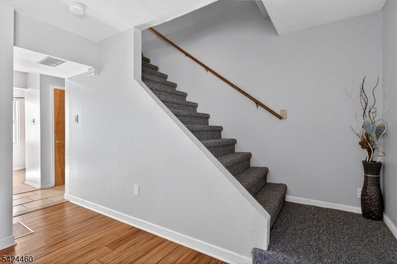 216 New Street, Unit A Orange, NJ 07050 - Photo 7 of 17 a view of entryway with wooden floor and stairs