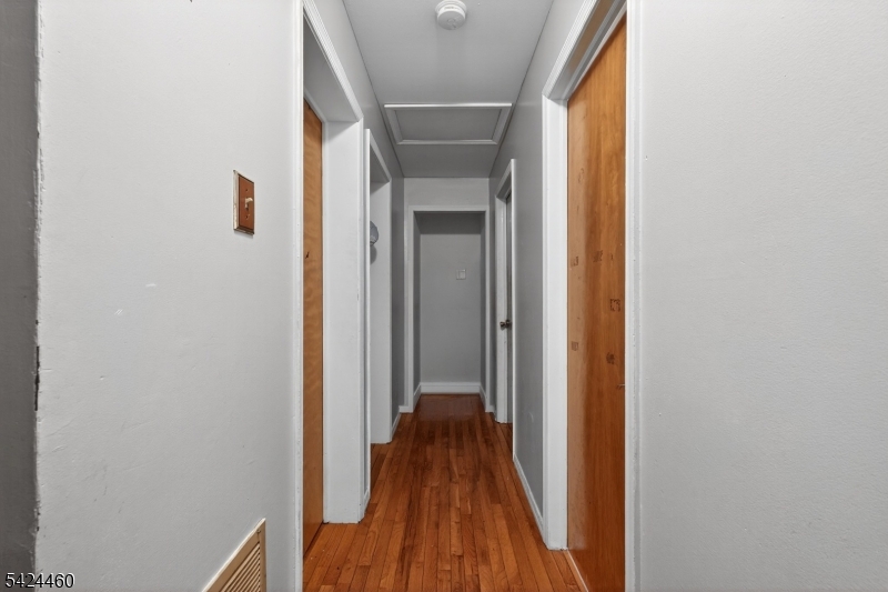 216 New Street, Unit A Orange, NJ 07050 - Photo 8 of 17 a view of a hallway with wooden floor