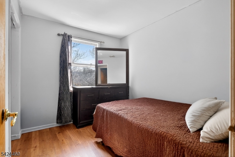 216 New Street, Unit A Orange, NJ 07050 - Photo 9 of 17 a bedroom with a bed and window