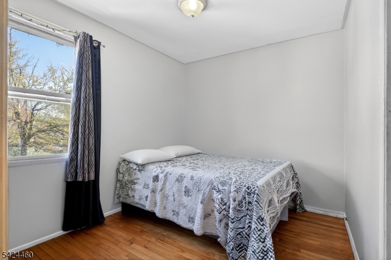216 New Street, Unit A Orange, NJ 07050 - Photo 10 of 17 a bedroom with a bed and a window