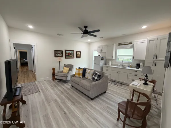 a living room with furniture and a flat screen tv