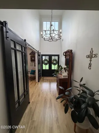 a view of a livingroom with furniture a chandelier