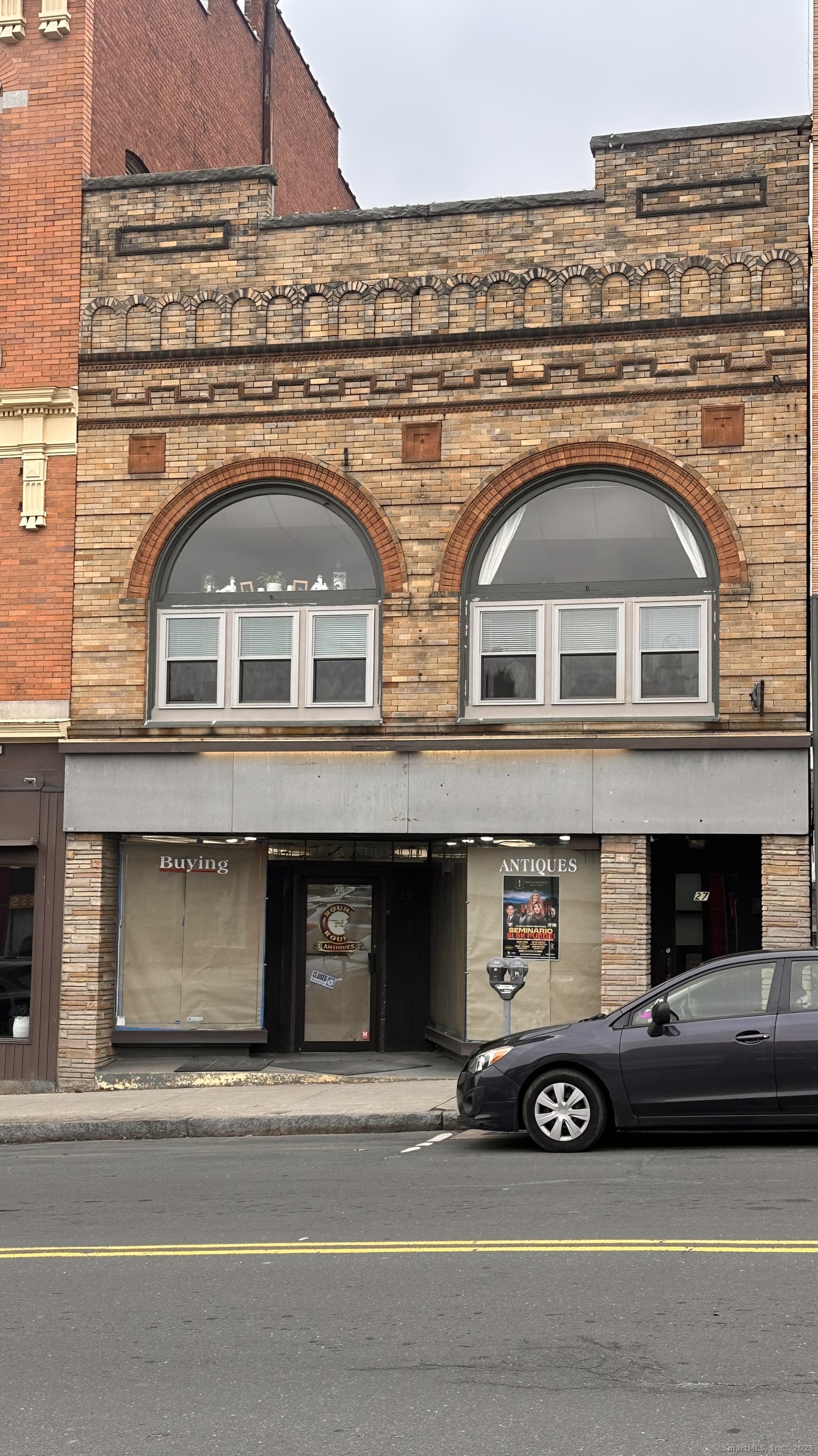 a front view of a house with a parking space and garage