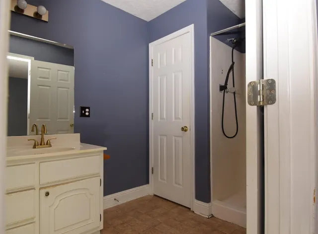 a bathroom with a sink vanity and a mirror