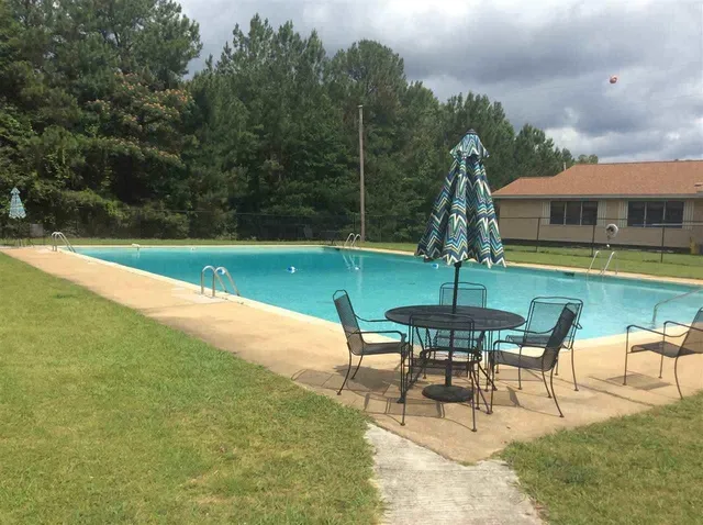 a view of a swimming pool with a table and chairs