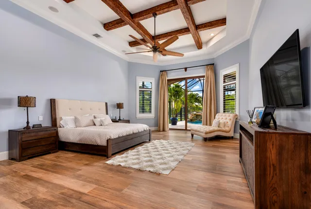 a living room with furniture a flat screen tv and a large window