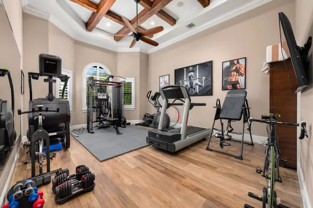 a room with gym equipment and a flat screen tv