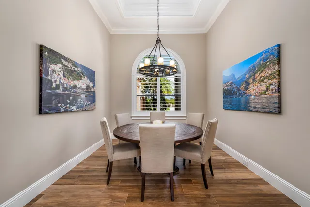 a dining room with furniture a rug and wooden floor