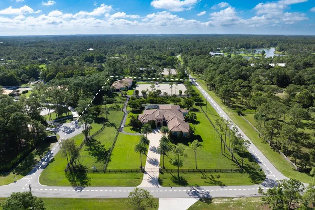an aerial view of residential houses with outdoor space and city view