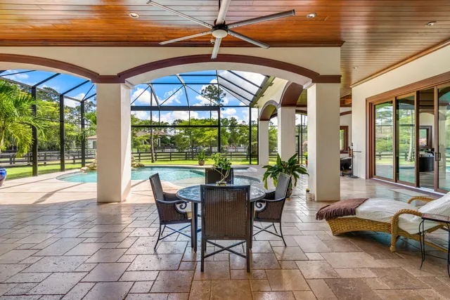 a dining room with balcony and furniture