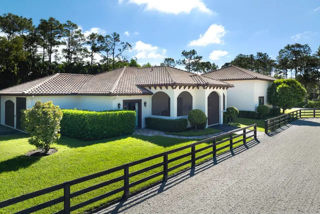 a view of a house with wooden fence