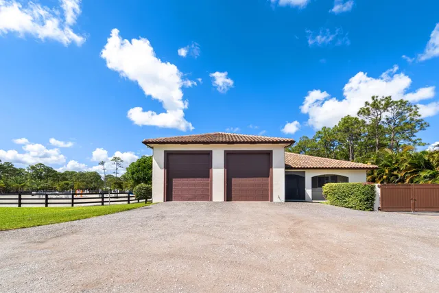 a view of a house with a yard and garage