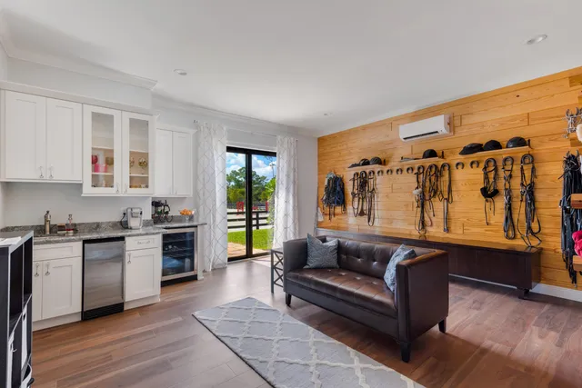 a living room with stainless steel appliances granite countertop furniture and a window