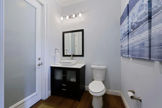 a bathroom with a toilet sink and mirror