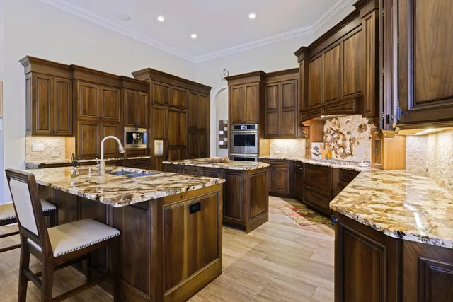 a kitchen with stainless steel appliances granite countertop wooden counter tops and wooden cabinets