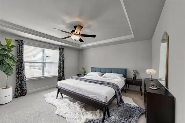 a bed sitting in a bedroom next to a window