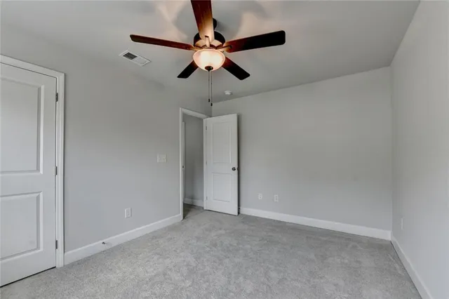 a view of a room with a ceiling fan