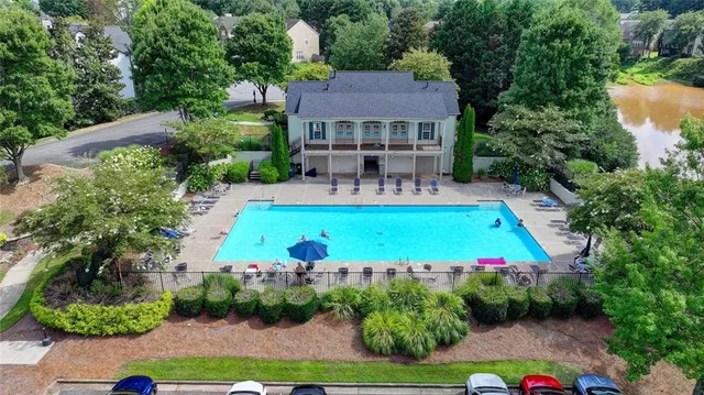 a view of house with swimming pool outdoor seating and yard