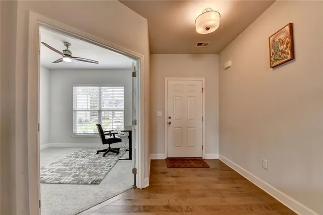 a view of a livingroom with wooden floor and a window