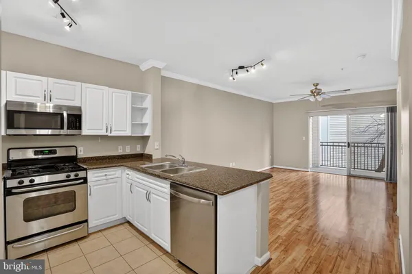 a kitchen with granite countertop a stove top oven and sink
