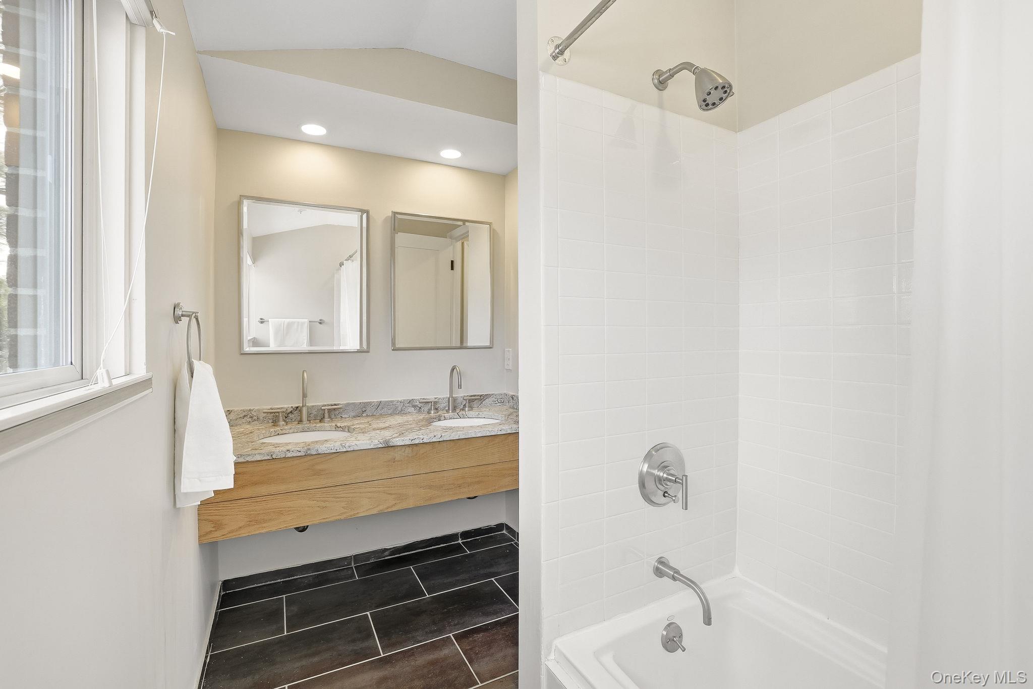 150 North Bedford Road, Unit 6D Chappaqua, NY 10514 - Photo 12 of 18 a bathroom with a bathtub a sink and a mirror