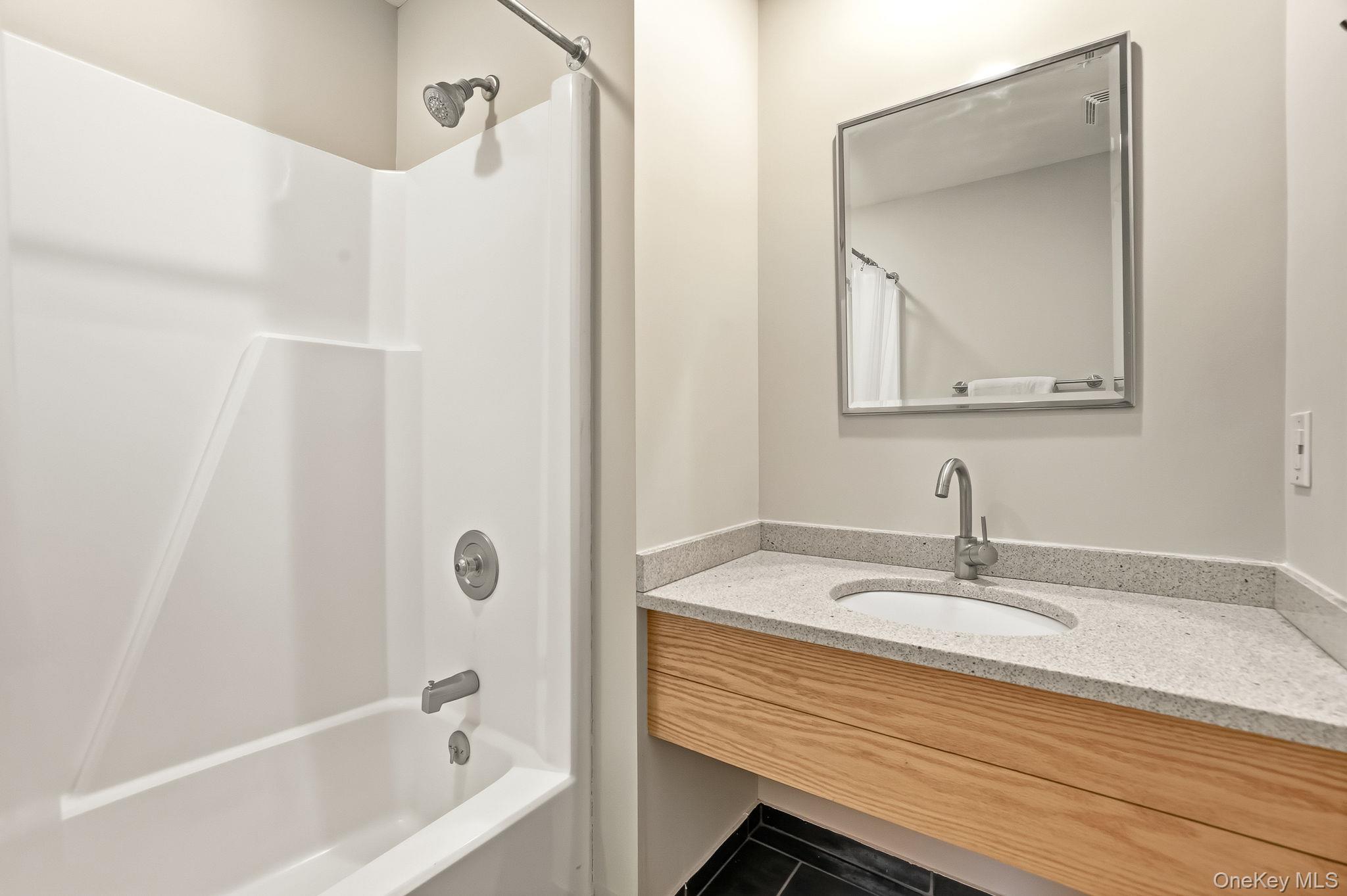 150 North Bedford Road, Unit 6D Chappaqua, NY 10514 - Photo 14 of 18 a bathroom with a sink and a mirror