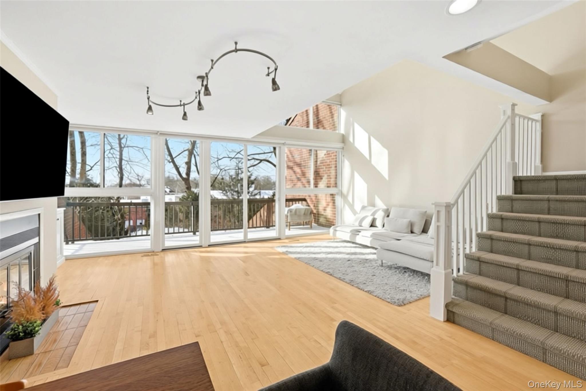 150 North Bedford Road, Unit 6D Chappaqua, NY 10514 - Photo 4 of 18 a view of an entryway with a floor to ceiling window and a kitchen
