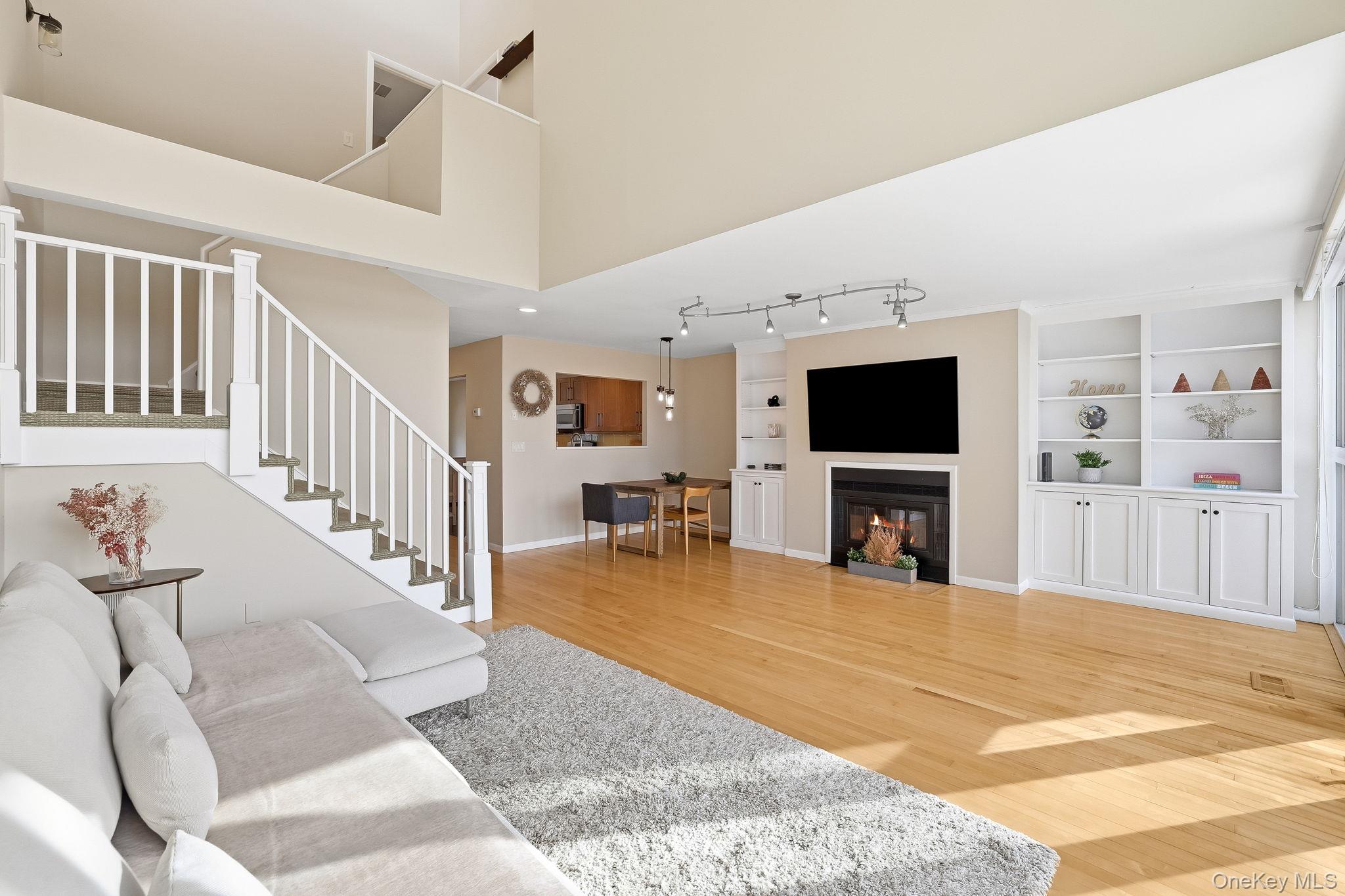 150 North Bedford Road, Unit 6D Chappaqua, NY 10514 - Photo 6 of 18 a view of a livingroom with furniture and a flat screen tv