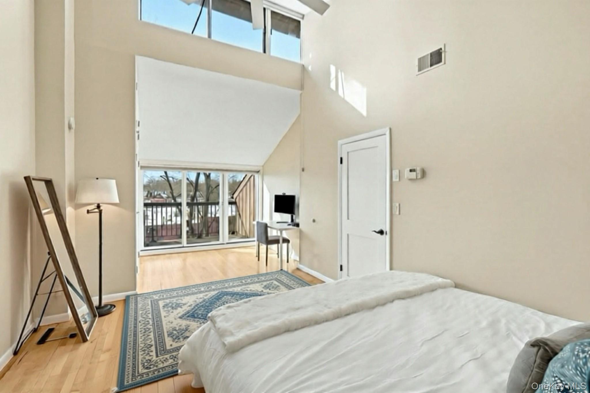 150 North Bedford Road, Unit 6D Chappaqua, NY 10514 - Photo 10 of 18 a bedroom with a bed window and a flat tv screen