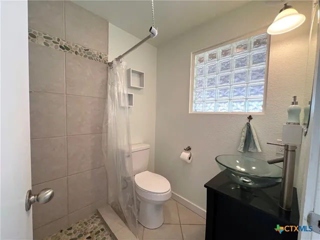 a view of a garden with flowers and trees