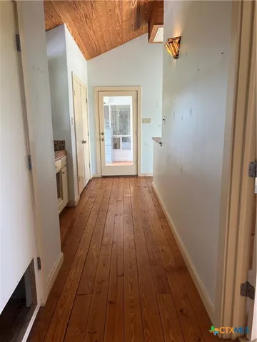 a view of a bedroom with wooden floor and cabinet