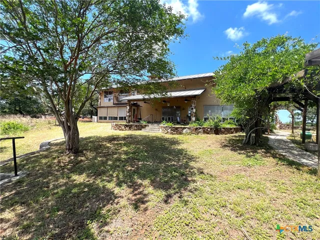 a spacious bedroom with a bed and wooden floor
