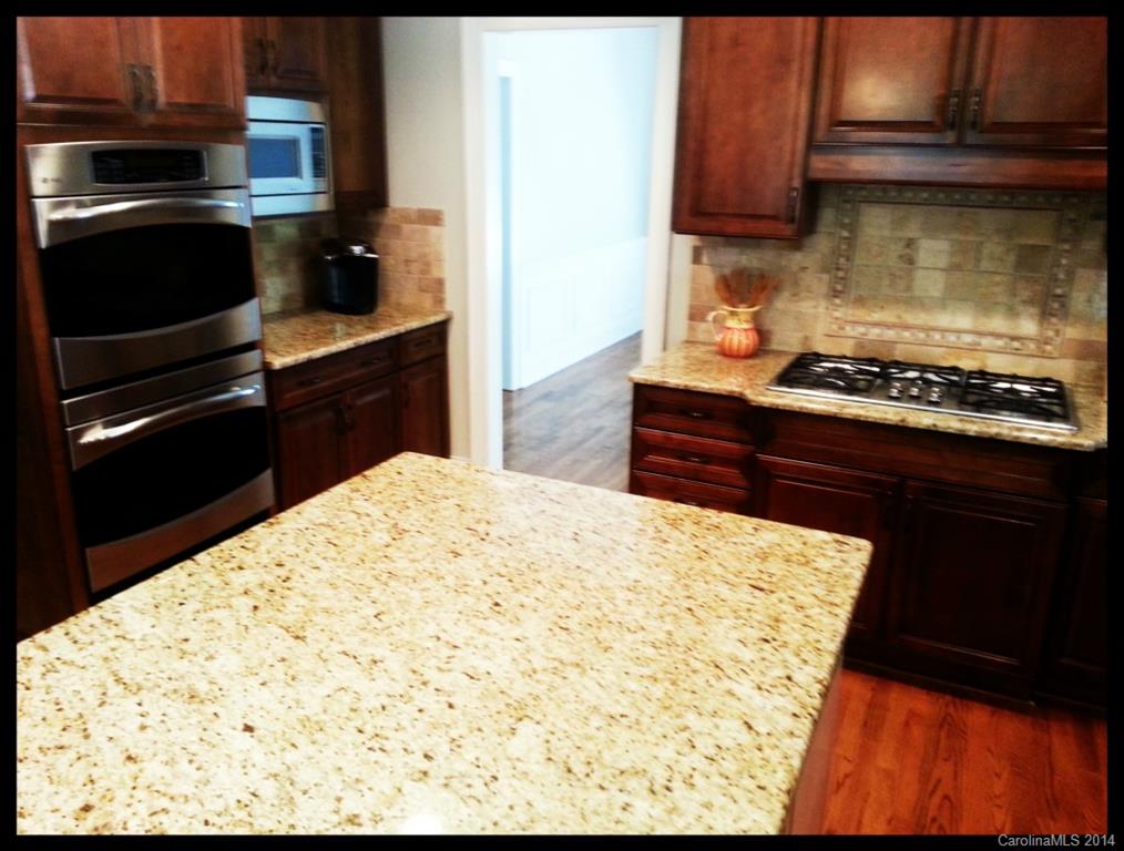 2420 High Ridge Road Charlotte, NC 28270 - Photo 8 of 24 a kitchen with a stove and a refrigerator