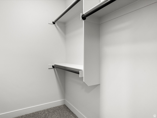 1159 North Broad Hollow Road Garden City, UT 84028 - Photo 53 of 55 Walk-in closet with white shelving and black metal hanging rods