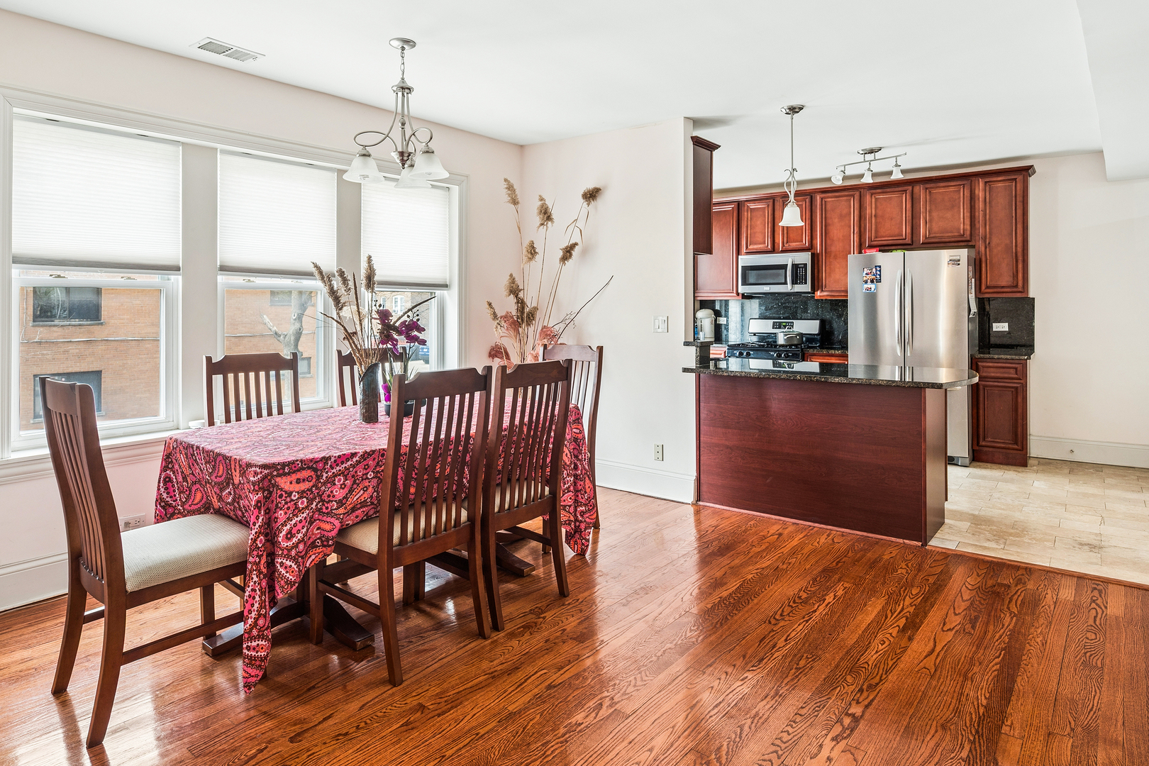 2656 West Lunt Avenue, Unit 1 Chicago, IL 60645 - Photo 2 of 12 a view of a dining room with furniture window and wooden floor