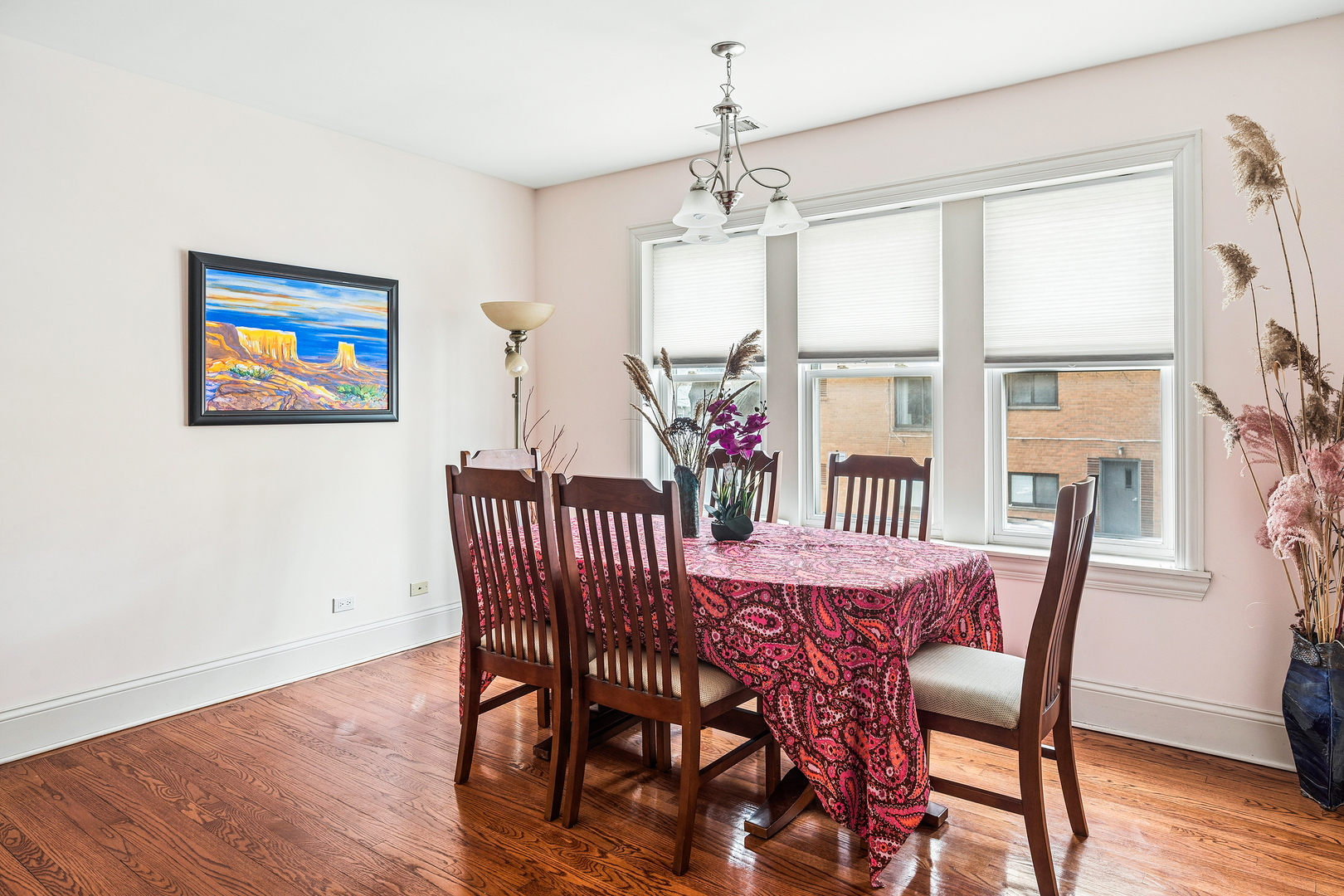 2656 West Lunt Avenue, Unit 1 Chicago, IL 60645 - Photo 3 of 12 a view of a dining room with furniture wooden floor and chandelier