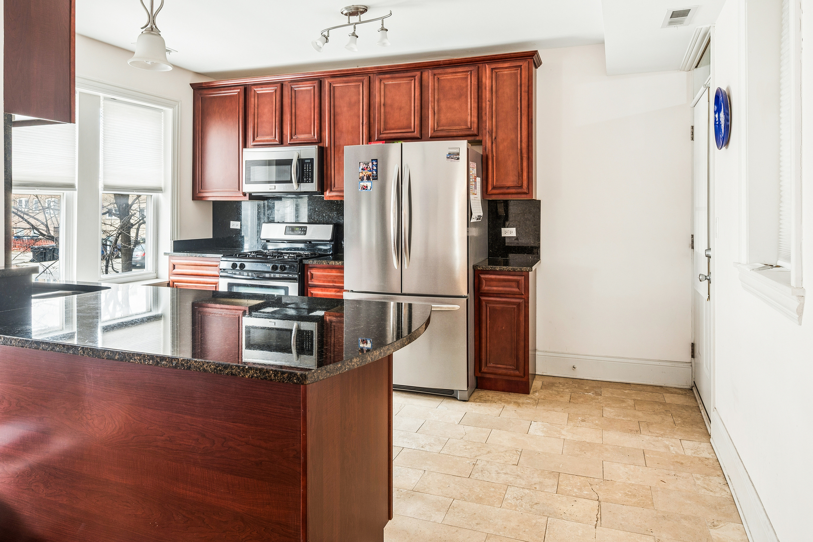 2656 West Lunt Avenue, Unit 1 Chicago, IL 60645 - Photo 4 of 12 a kitchen with stainless steel appliances a refrigerator and a stove top oven