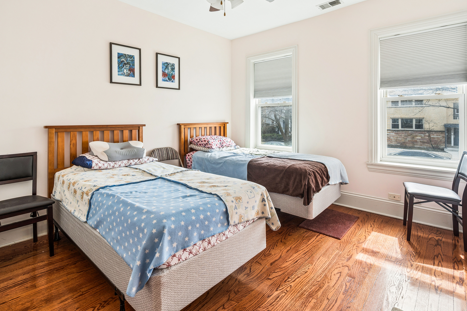 2656 West Lunt Avenue, Unit 1 Chicago, IL 60645 - Photo 9 of 12 a bedroom with beds and a window