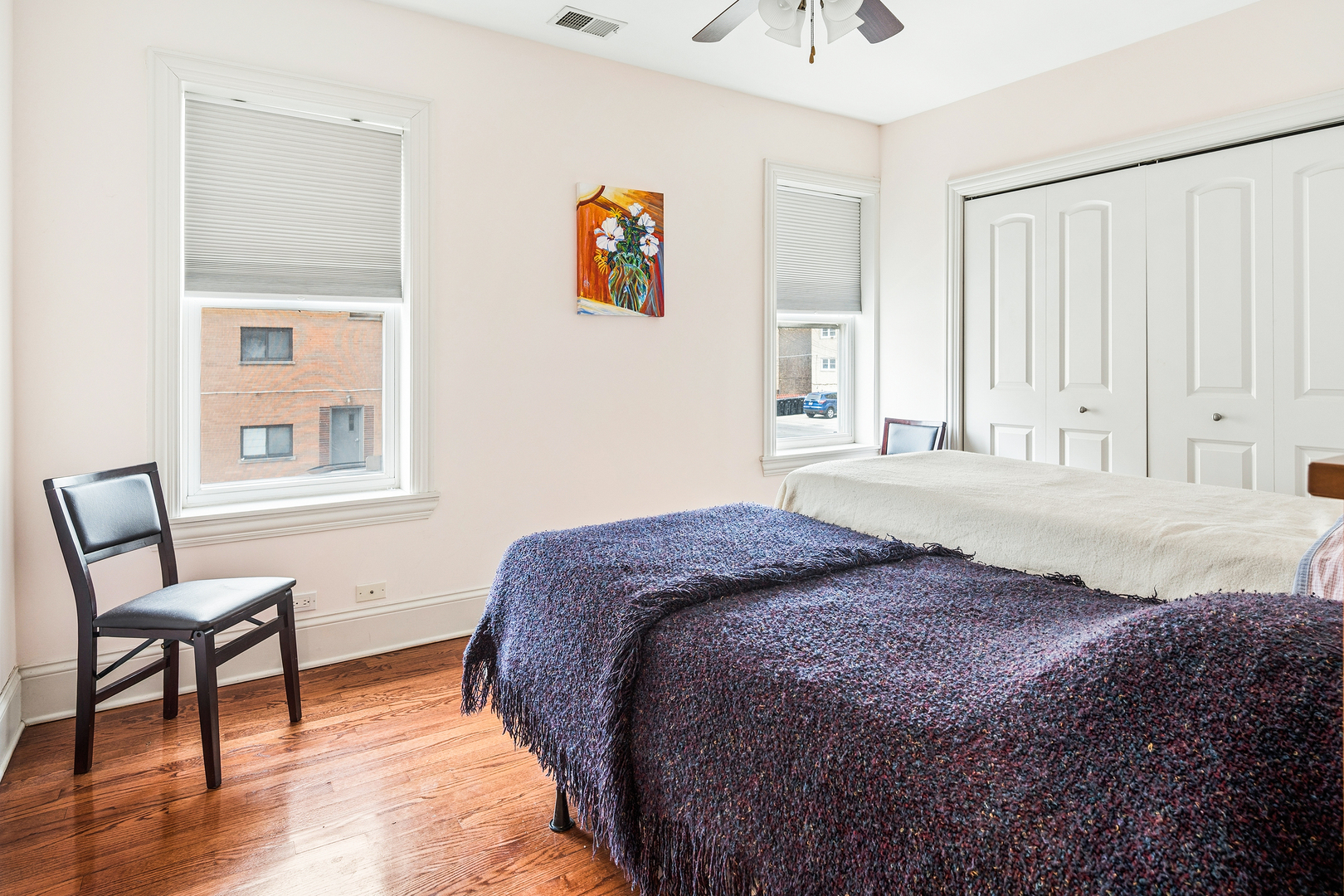 2656 West Lunt Avenue, Unit 1 Chicago, IL 60645 - Photo 10 of 12 a bedroom with a bed and wooden floor