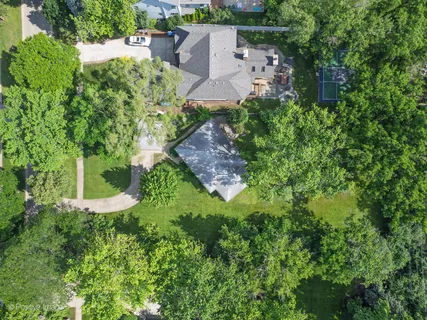 an aerial view of a house with a yard and lake view