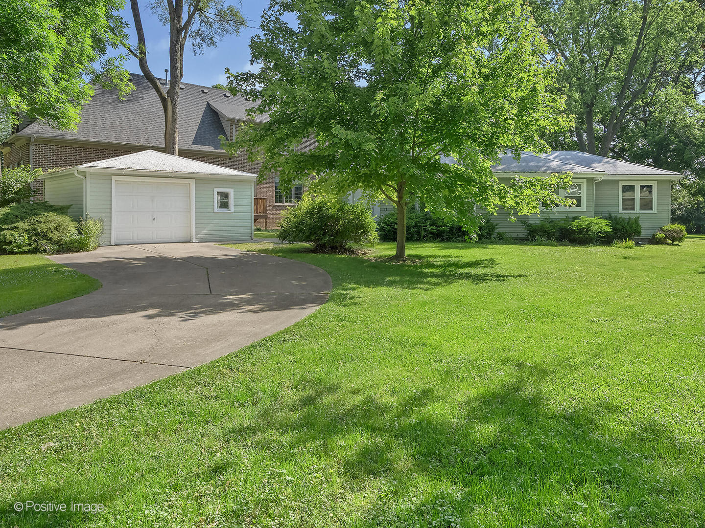241 Coe Road Clarendon Hills, IL 60514 - Photo 5 of 12 a front view of a house with a yard and trees