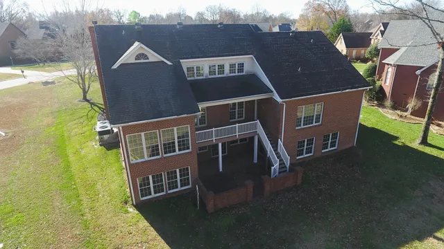 an aerial view of a house with swimming pool