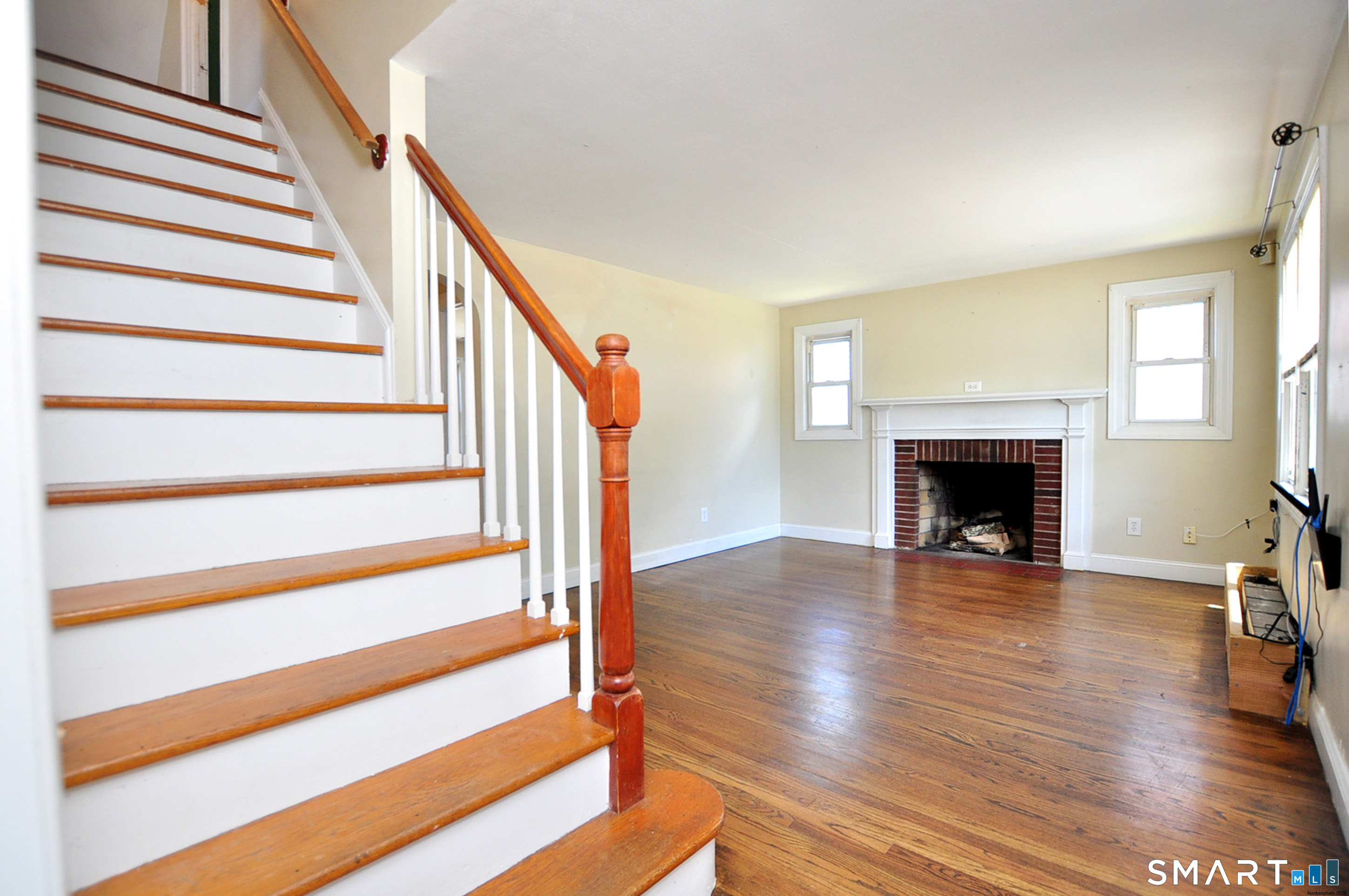 103 West Center Street Manchester, CT 06040 - Photo 8 of 29 a view of a livingroom with wooden floor and a fireplace