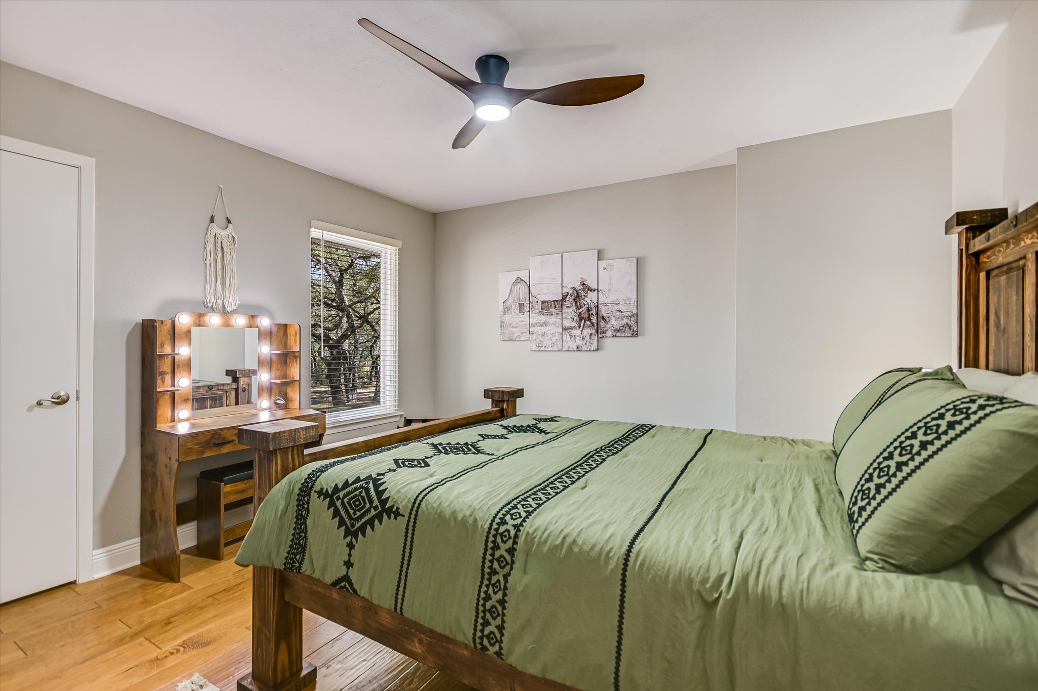 878 Ranch Road 2766 Johnson City, TX 78636 - Photo 20 of 40 a bedroom with a bed and a chandelier