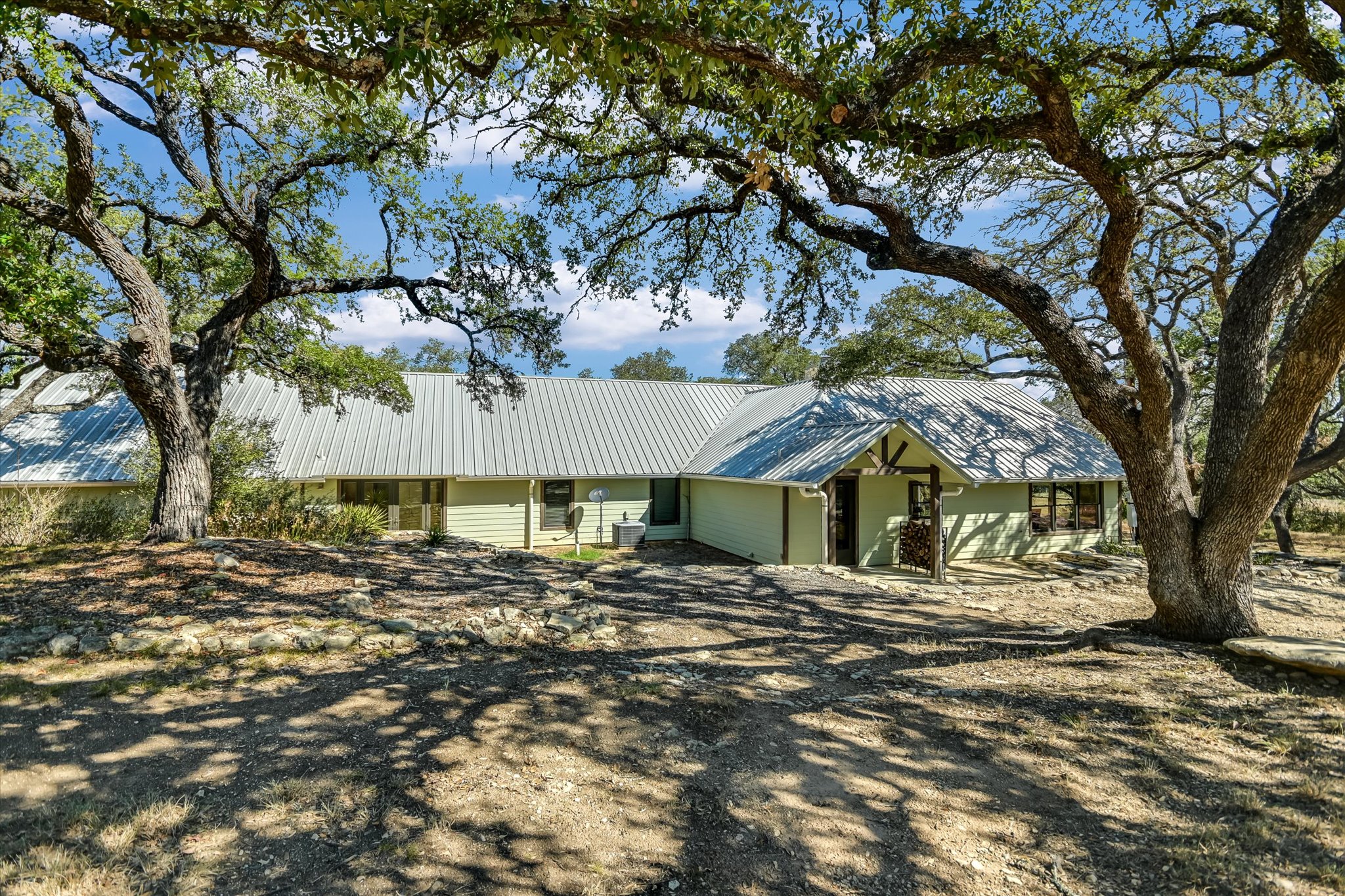 878 Ranch Road 2766 Johnson City, TX 78636 - Photo 24 of 40 a front view of a house with a yard
