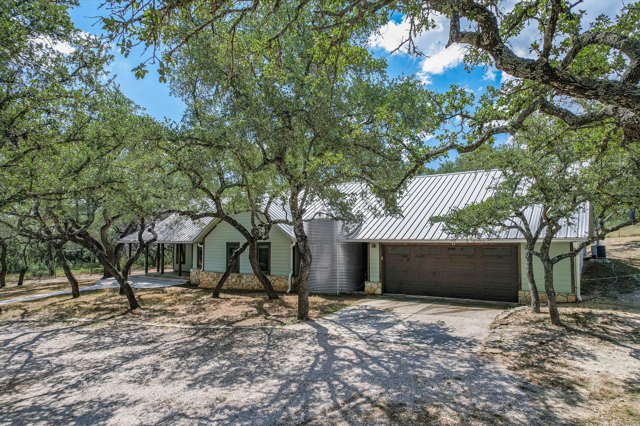 878 Ranch Road 2766 Johnson City, TX 78636 - Photo 40 of 40 a front view of a house with a yard and garage